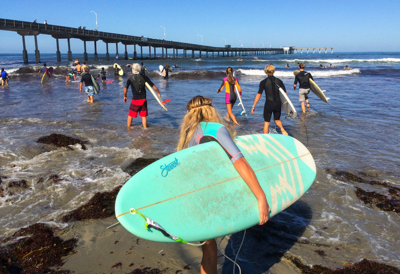 Surfers carry out ocean pollution awareness with paddle around Ocean Beach Pier